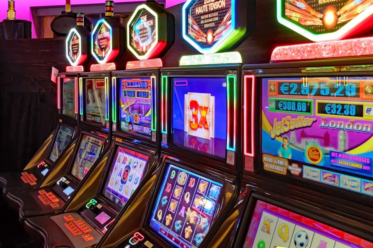 77j casino slot machine lobby showing colourful game tiles on mobile screen